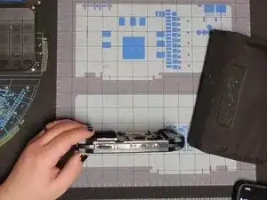 Then, insert a spudger between the L button and the face plate and separate them. Then, do the same on the right.