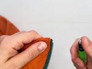 Use a lighter to singe frayed or damaged zipper tape.