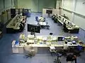 indoor air traffic control center; approach sectors, departure sectors, supervisor's desk, flight data area, etcetera