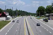 An urban expressway segment of King's Highway 11 in Severn, Ontario. Note the driveway access immediately preceding the exit ramp.