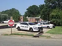 Parking aisle for police cars at a police station in the United States: highway=service service=parking_aisle access=no emergency=designated