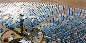 The Solar Two solar-thermal power project near Daggett, California. Every mirror in the field of heliostats reflects sunlight continuously onto the receiver on the tower.