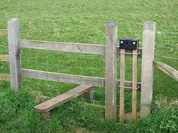 stile=stepover + dog_gate=yes Stiles where there is a liftable device to allow a dog to pass through
