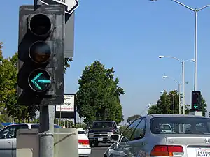 An arrow on a traffic signal that specifically applies to the lane